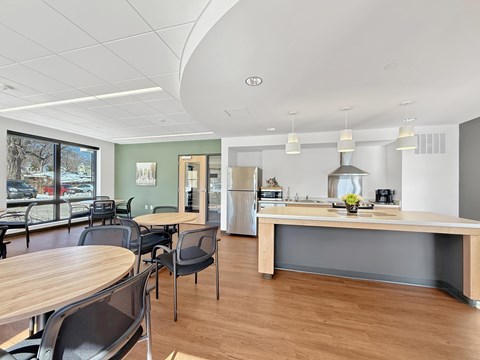 Another view of the Stryker Senior Apartments in West St. Paul Community Room with a wooden table and chairs.