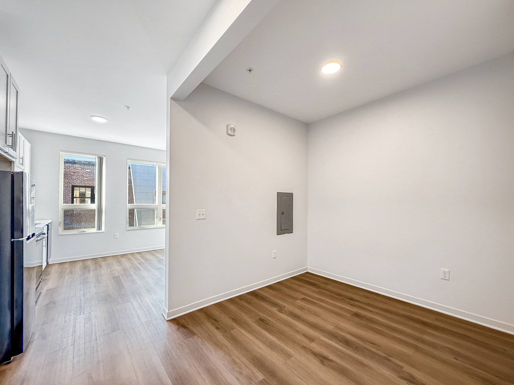 A room with wooden floors and white walls.