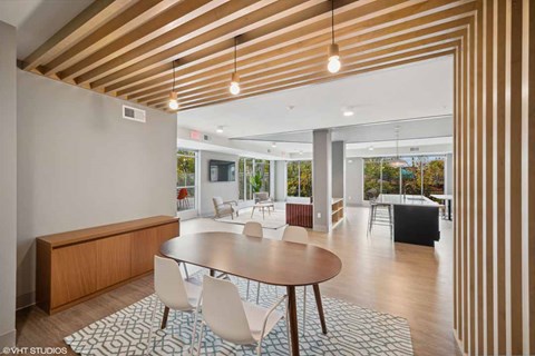 A modern dining room with a round table and chairs.