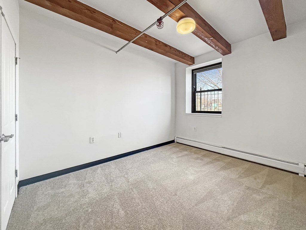 A room with a window and a door.