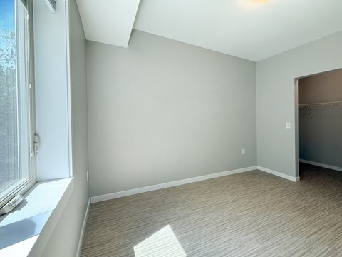 A room with a window and a door.