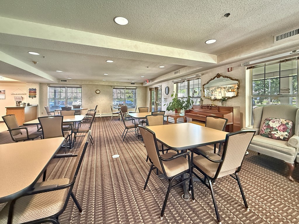 A room with tables and chairs and a couch.