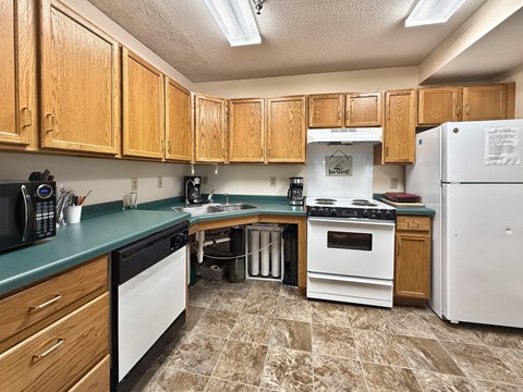 A kitchen with wooden cabinets and a white refrigerator.