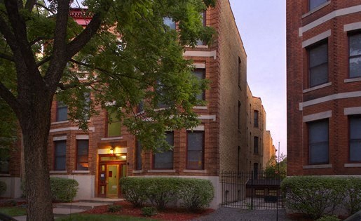 A building with a red door is seen in the image.
