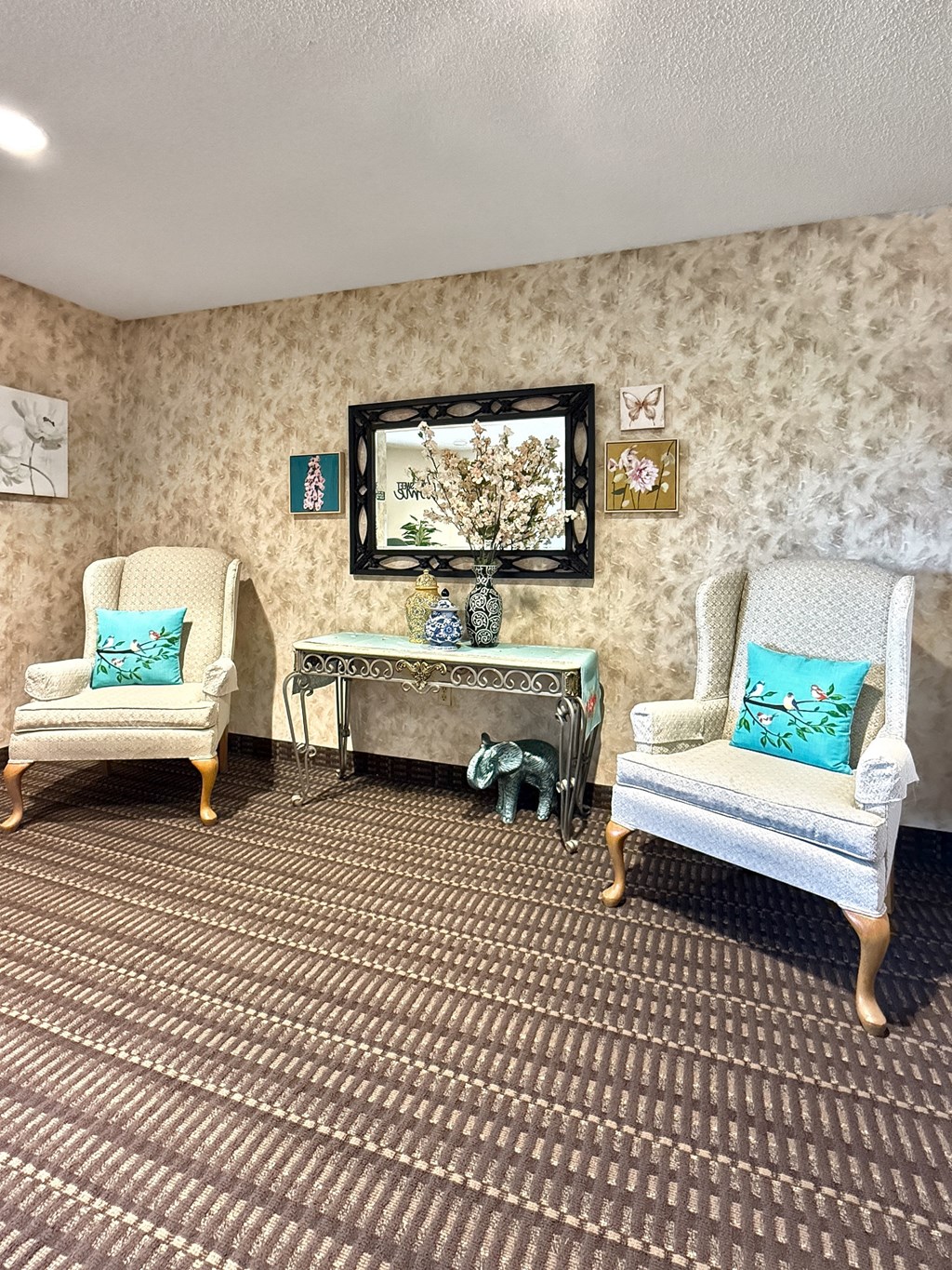 A room with two chairs and a bench.