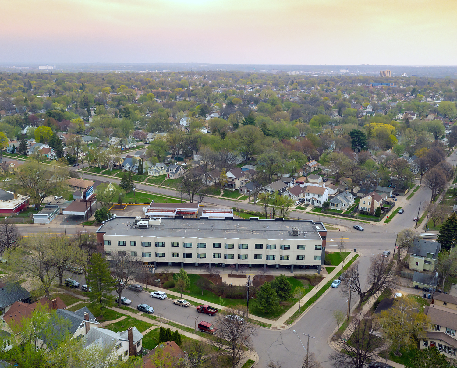 A large building sits in the middle of a residential area.