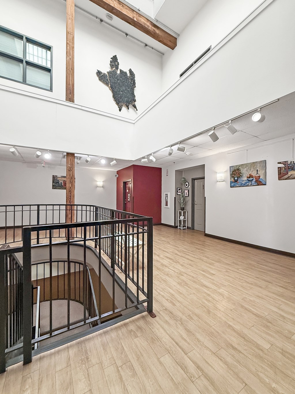 A staircase with a black railing and wooden steps.