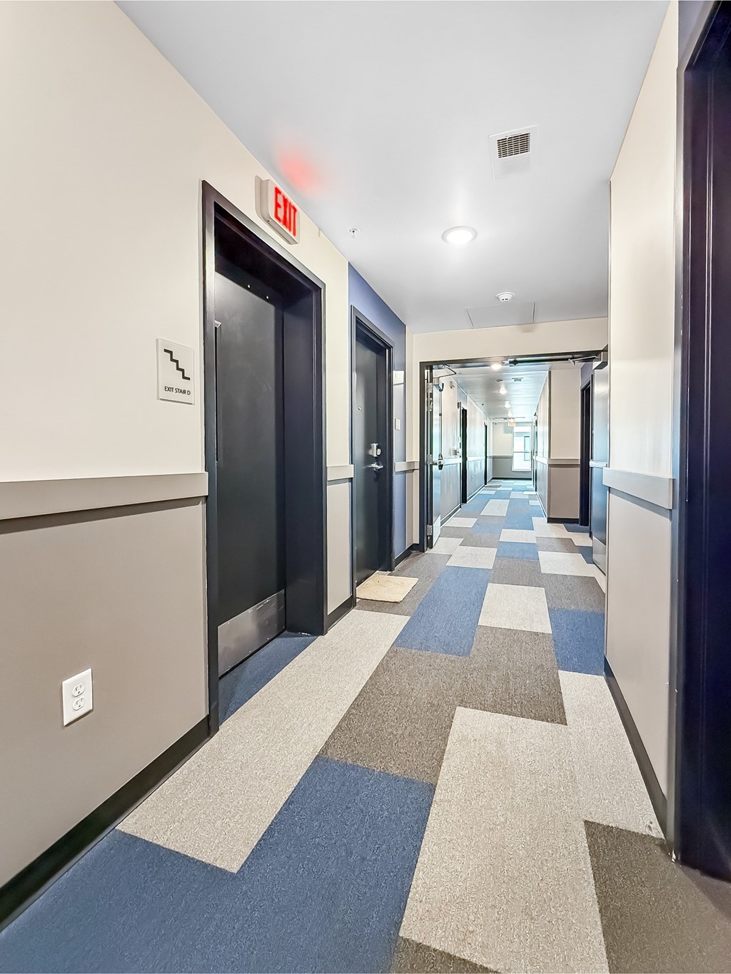 A long hallway with a blue and white checkered floor.