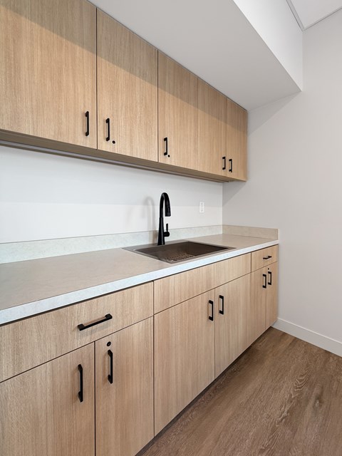 A kitchen with wooden cabinets and a white countertop.