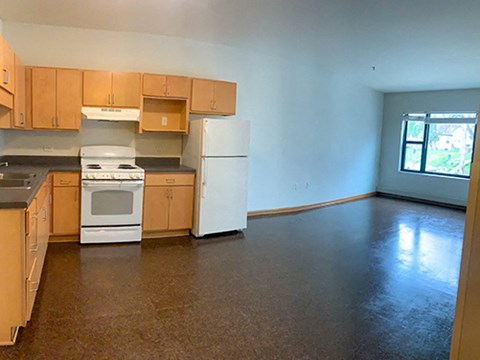 A kitchen with brown cabinets and a white stove top oven.