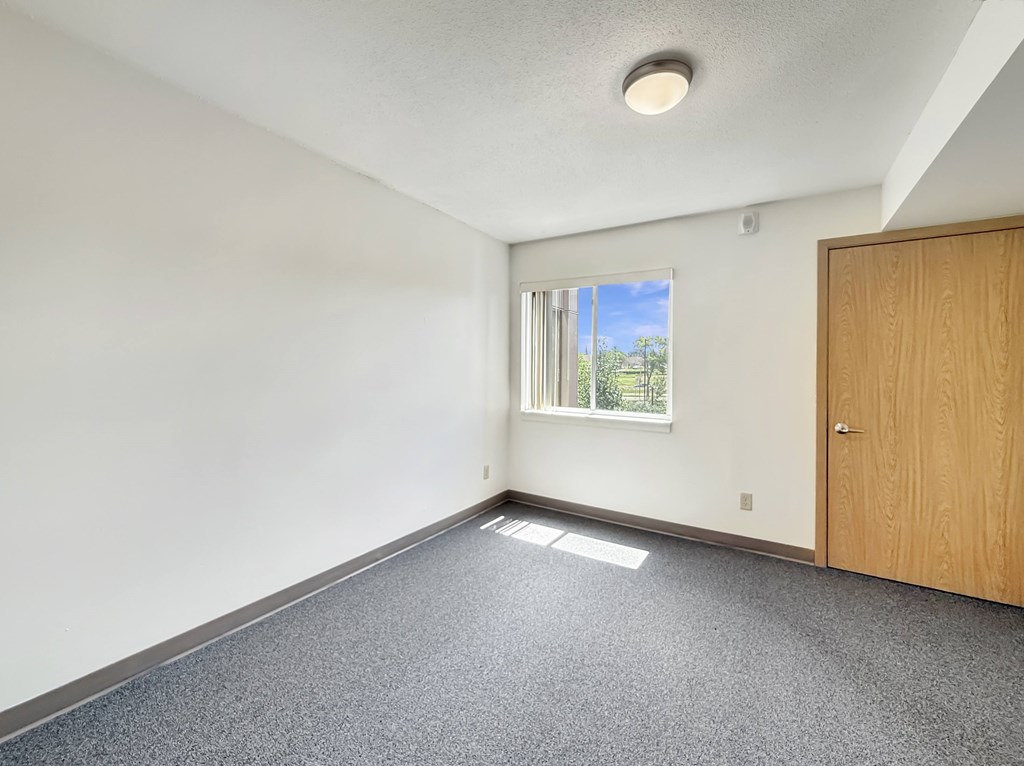 A room with a window and a door.