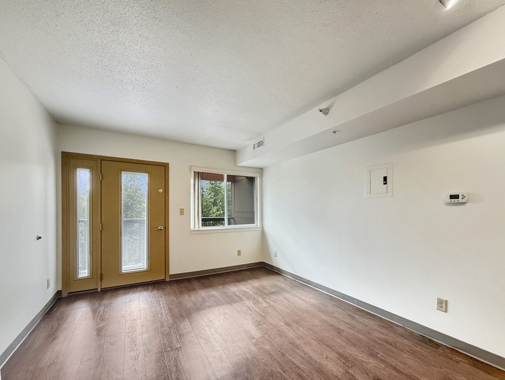 A room with wooden floors and white walls.