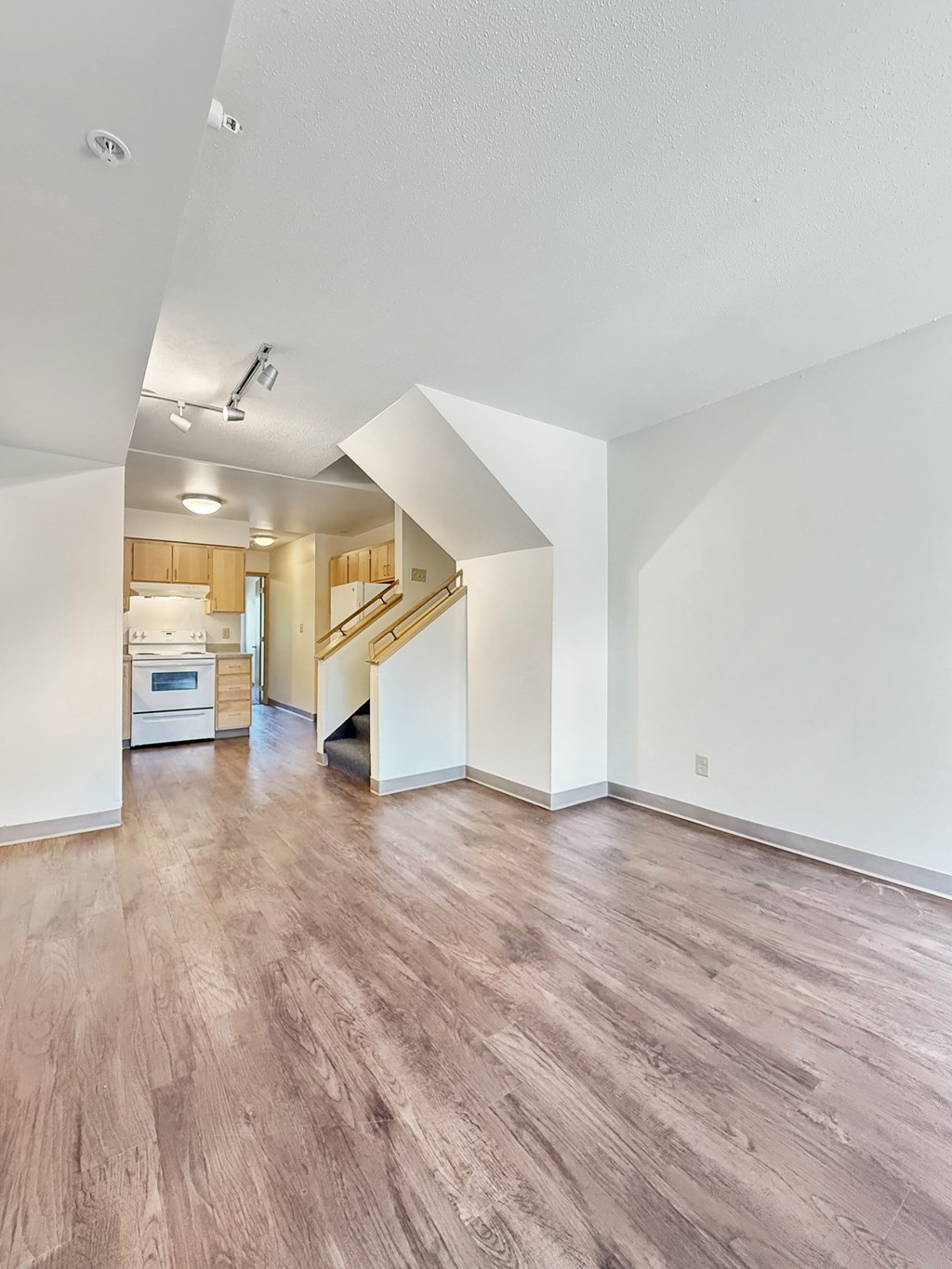 A room with wooden floors and white walls.