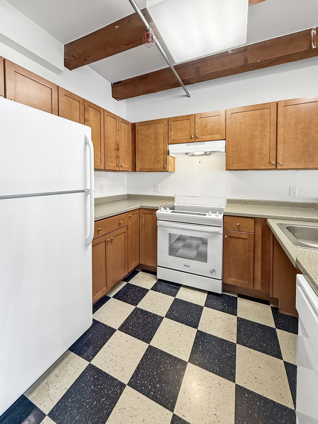 A kitchen with black and white checkered floor.