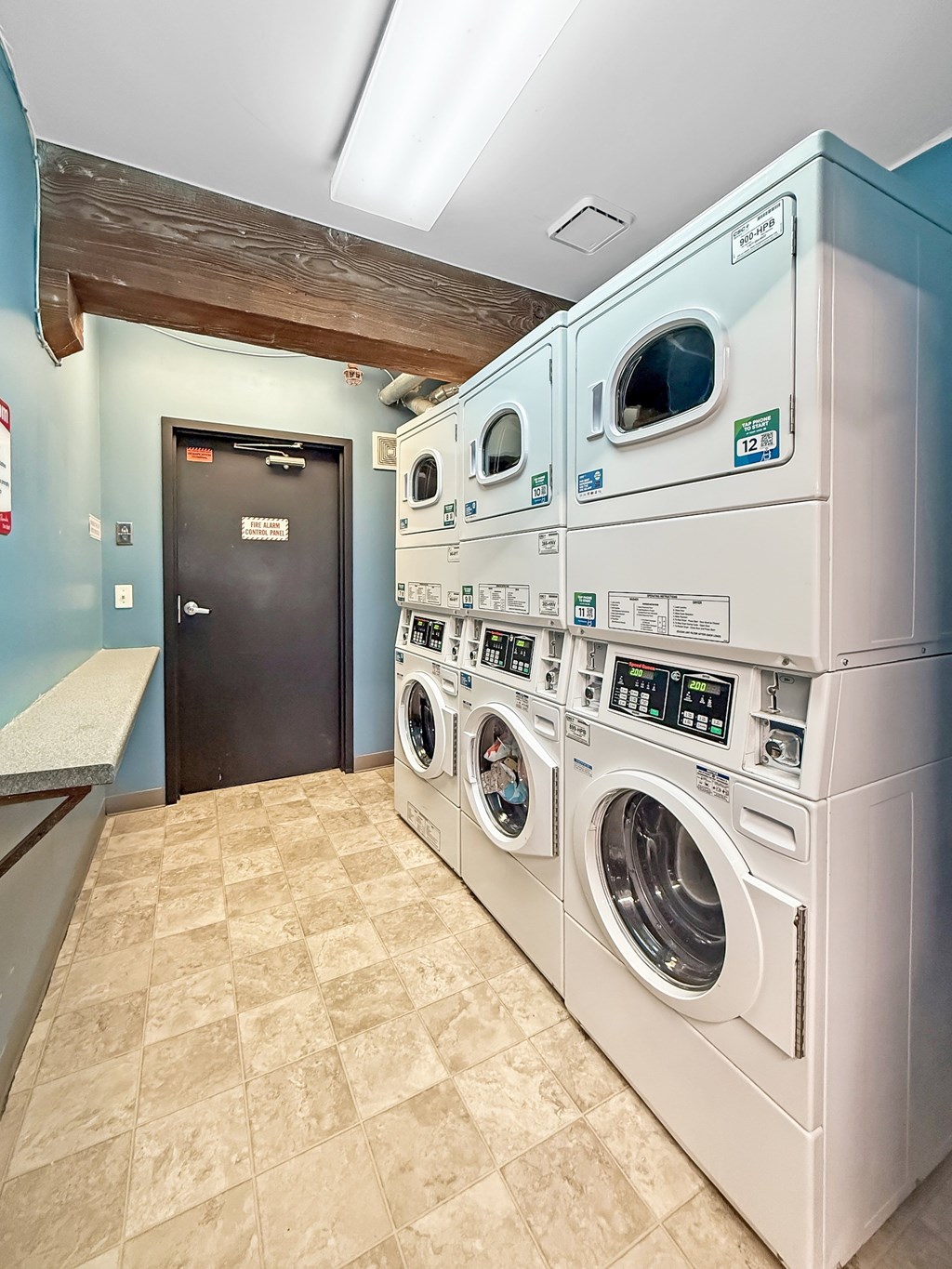 A row of washing machines in a laundromat.