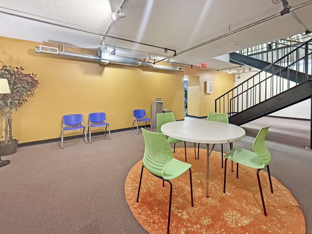 A room with a round table and chairs.