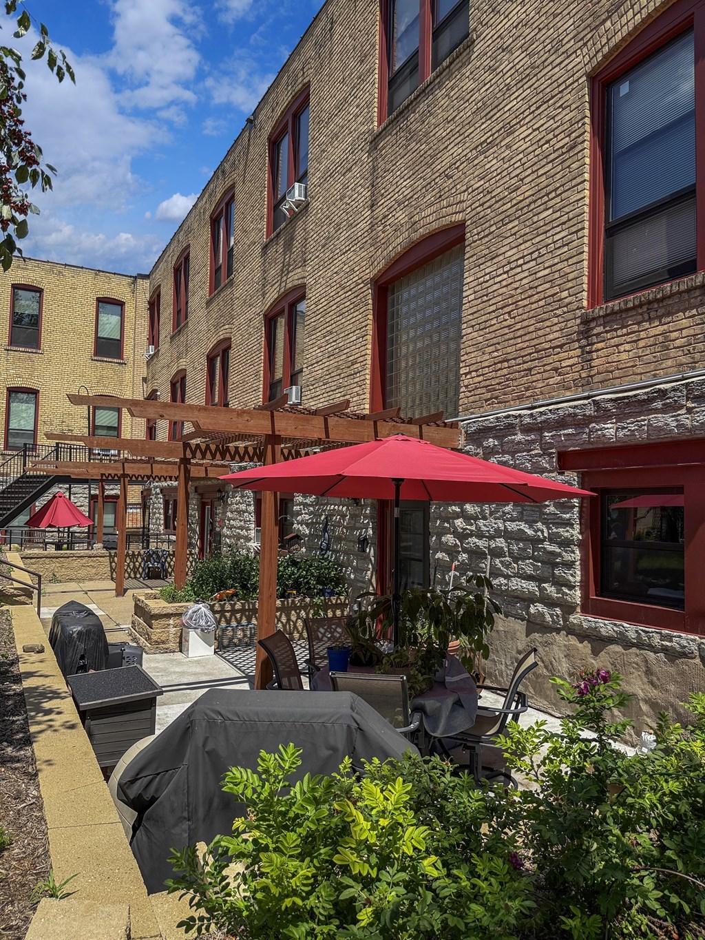 A patio and red umbrella at 653 Artists Lofts