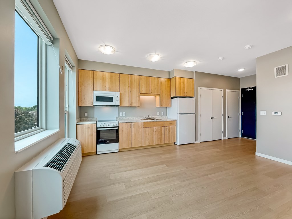 A kitchen with wooden cabinets and a white refrigerator.
