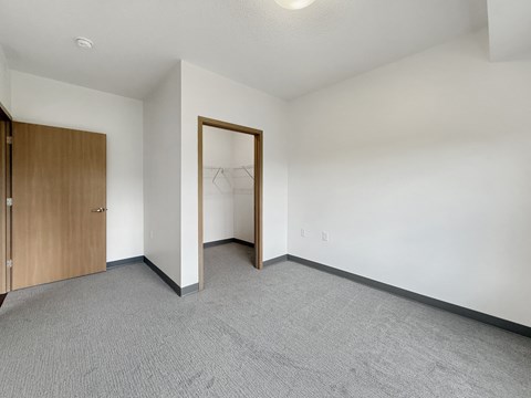 Another view of a bedroom at Trail Pointe Ridge apartments showing the closet and bedroom door