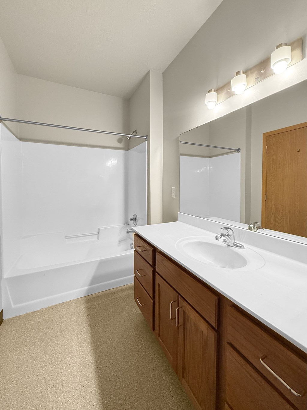 A bathroom with a white sink and a white tub/shower.