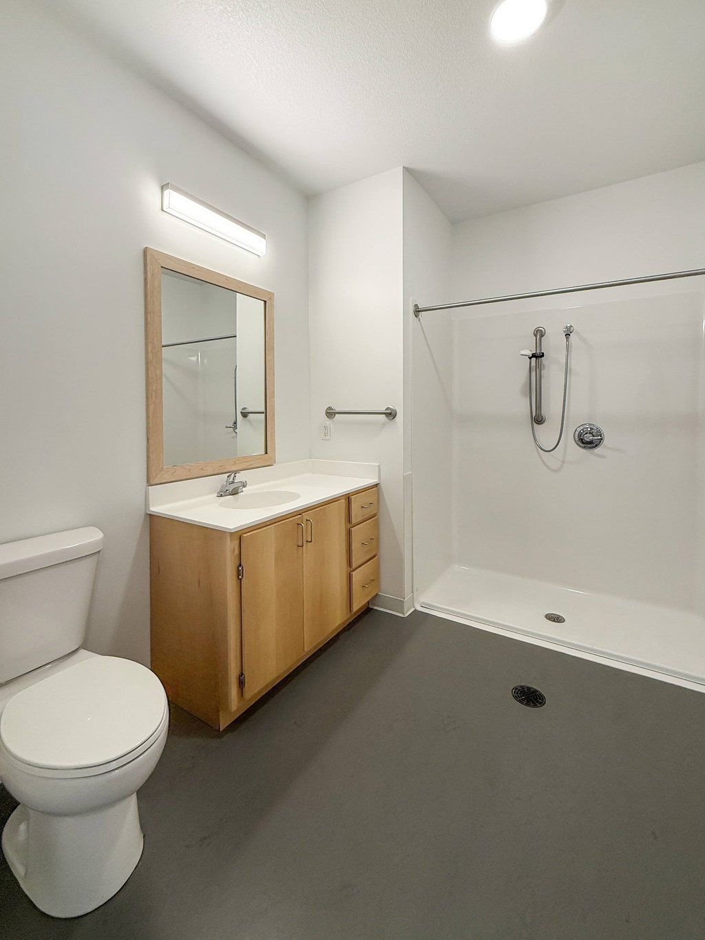 A white toilet sits next to a sink in a bathroom.