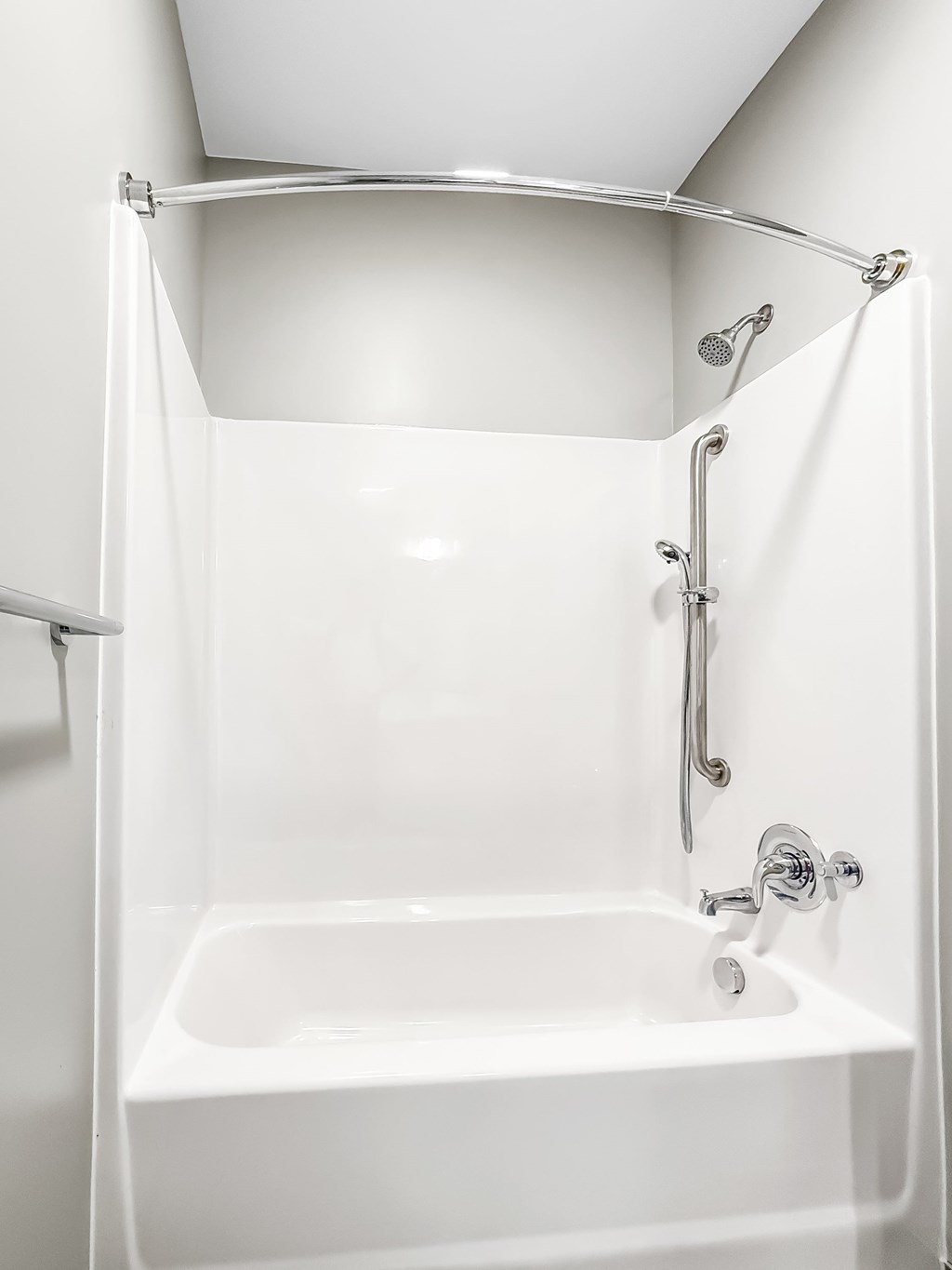 A white bathroom with a shower and tub.