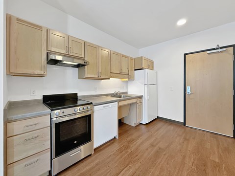 A kitchen with wooden cabinets and stainless steel appliances.