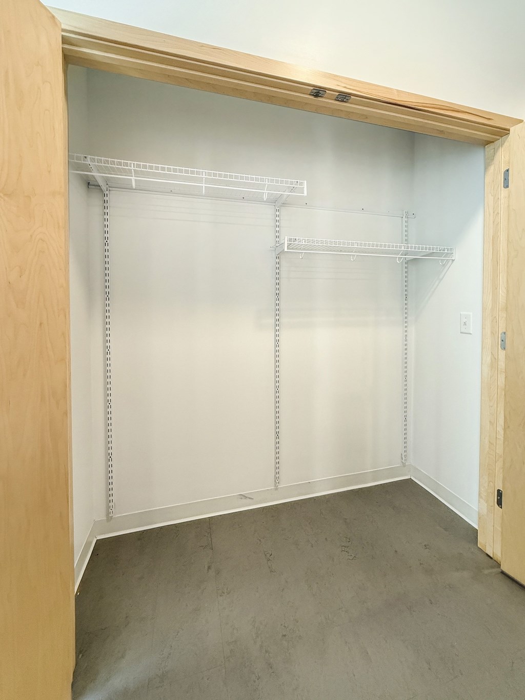 A walk-in closet with shelves and a wooden door.