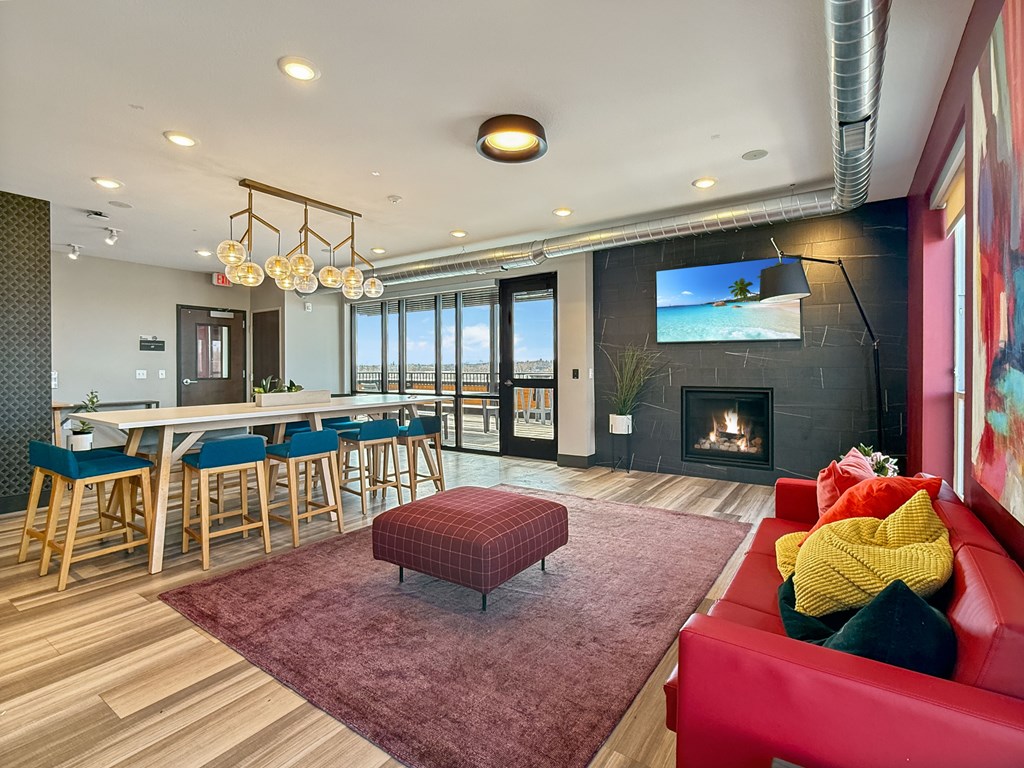 A modern living room with a red couch and a fireplace.