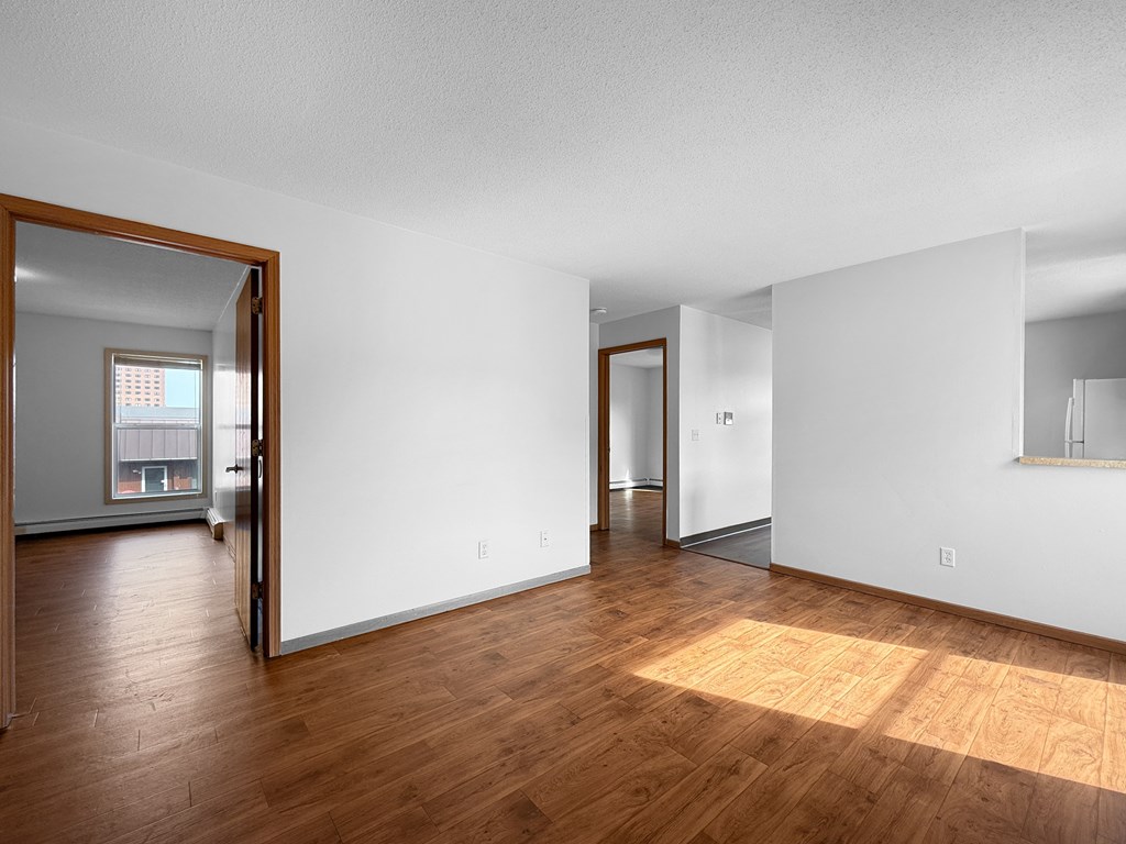 A room with wooden floors and white walls.