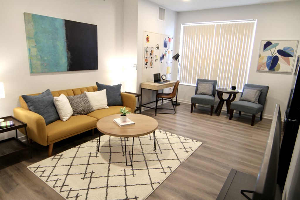 a living room with a couch and chairs and a table