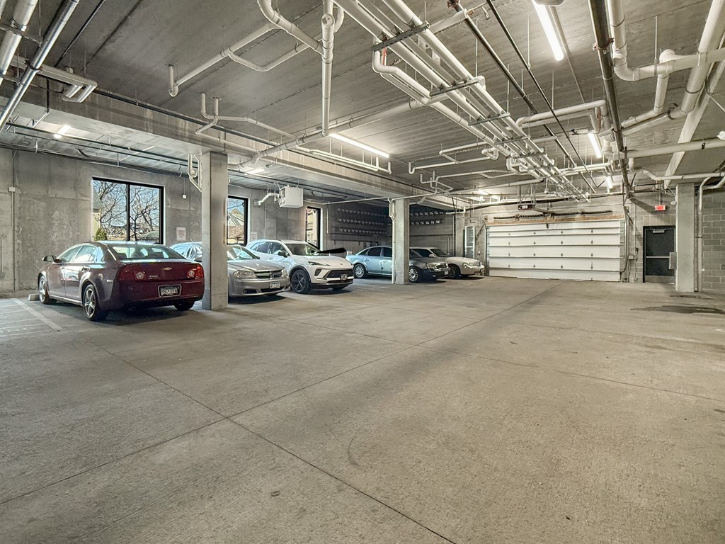 A parking garage with several cars parked inside.