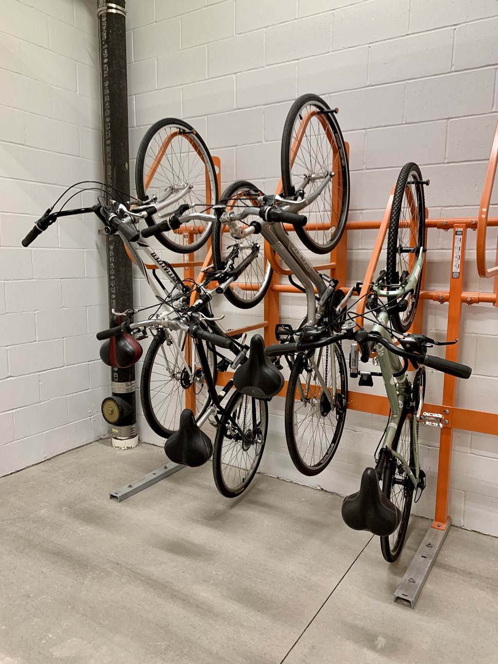 a row of bikes hanging on a rack in a garage
