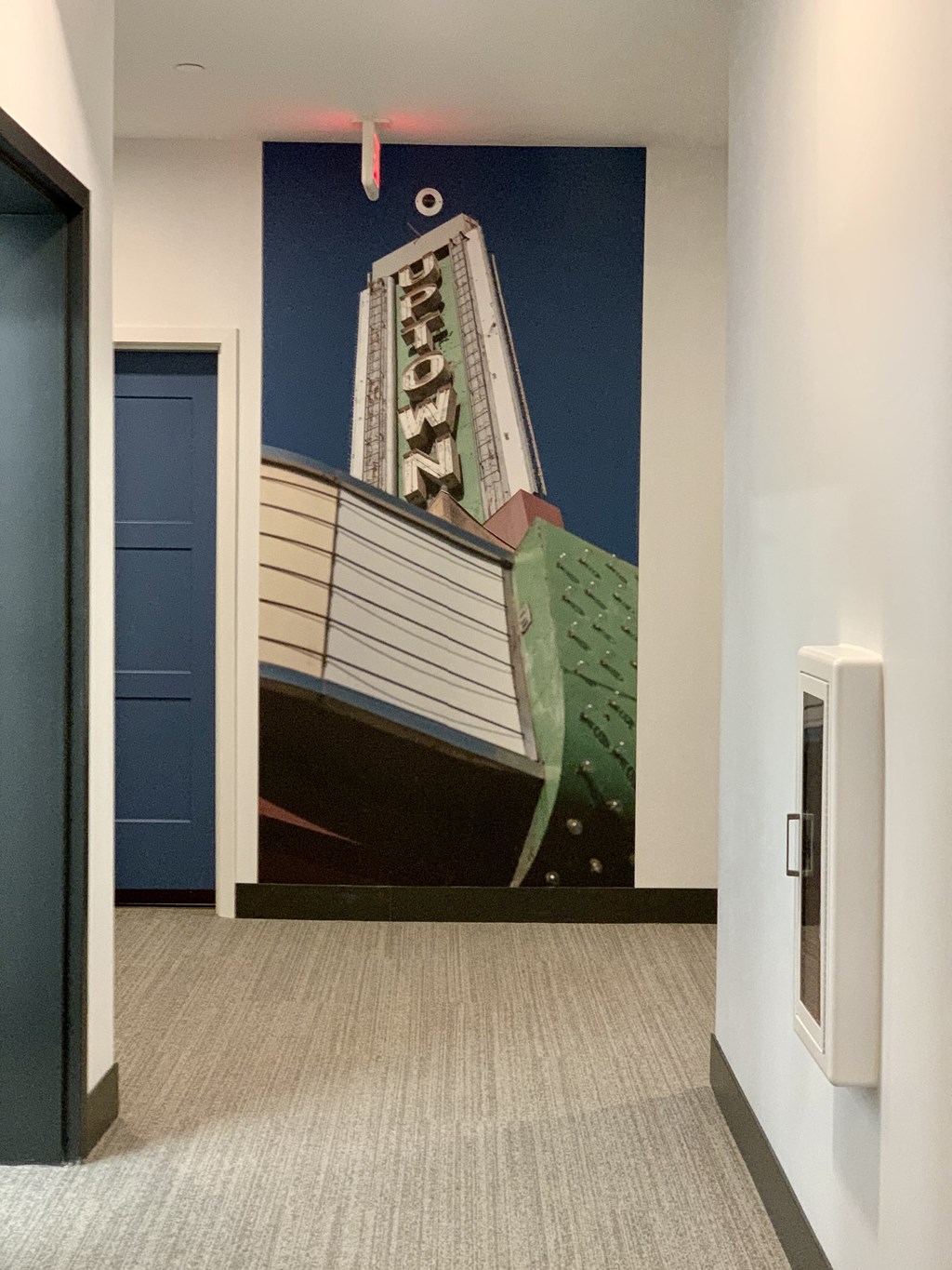 a mural of a building on the wall of a hallway