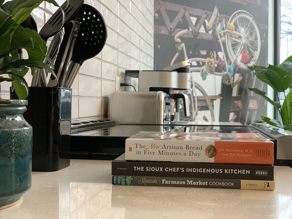 a stack of books sitting on a counter in a kitchen