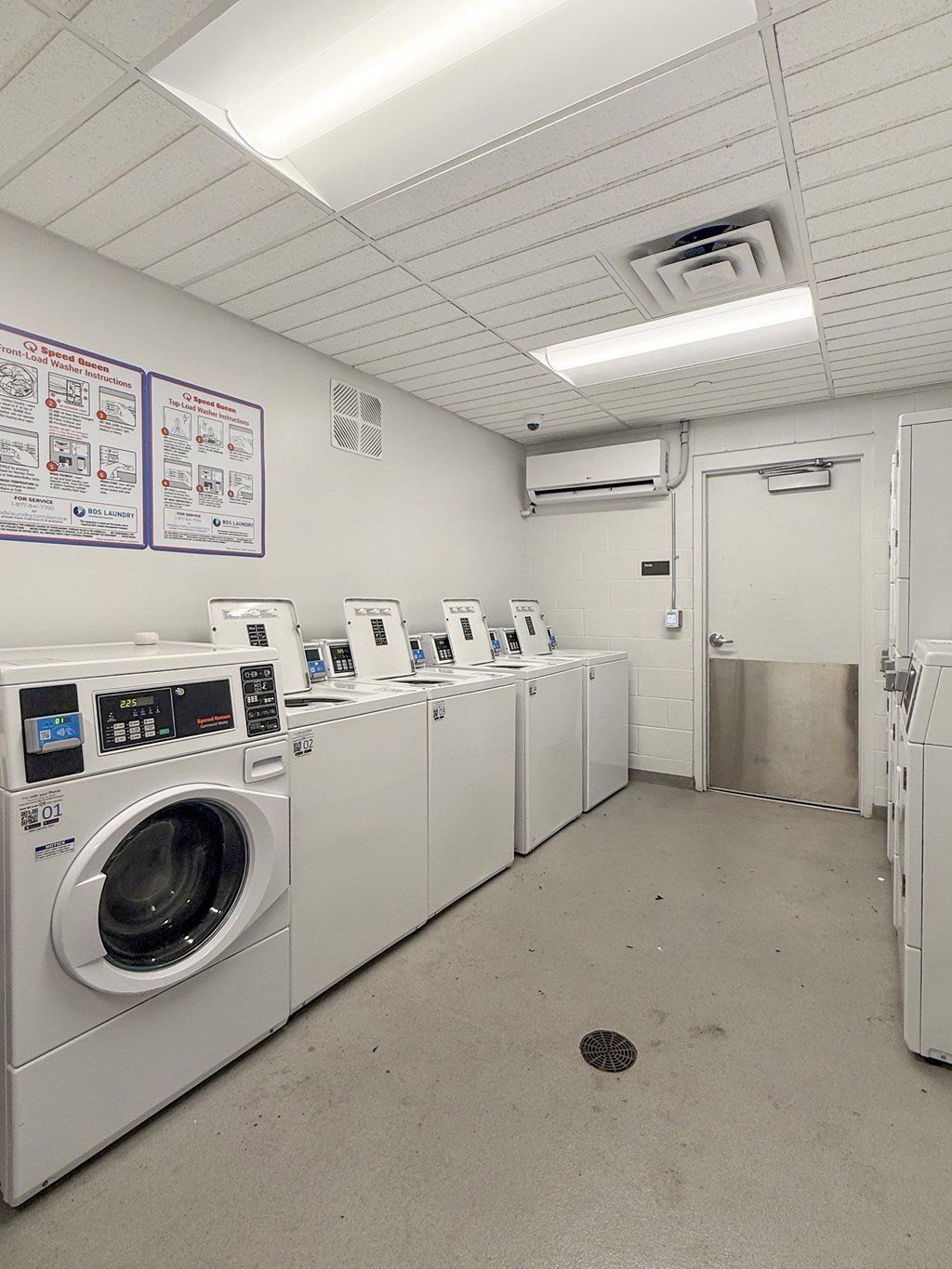 A row of washing machines in a laundromat.