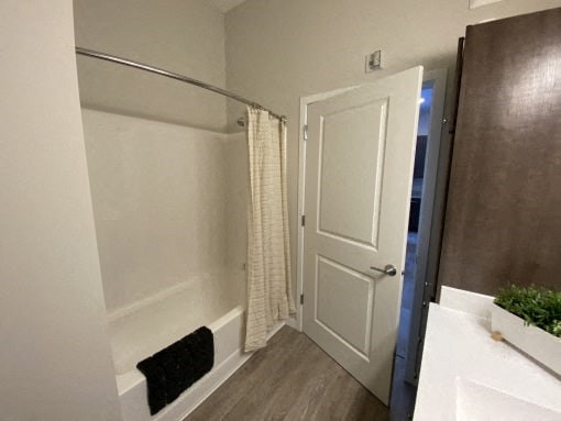 A bathroom with a white door and a white sink.
