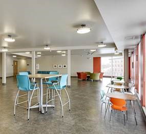 A room with tables and chairs.