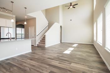 a kitchen and living room with hardwood floors