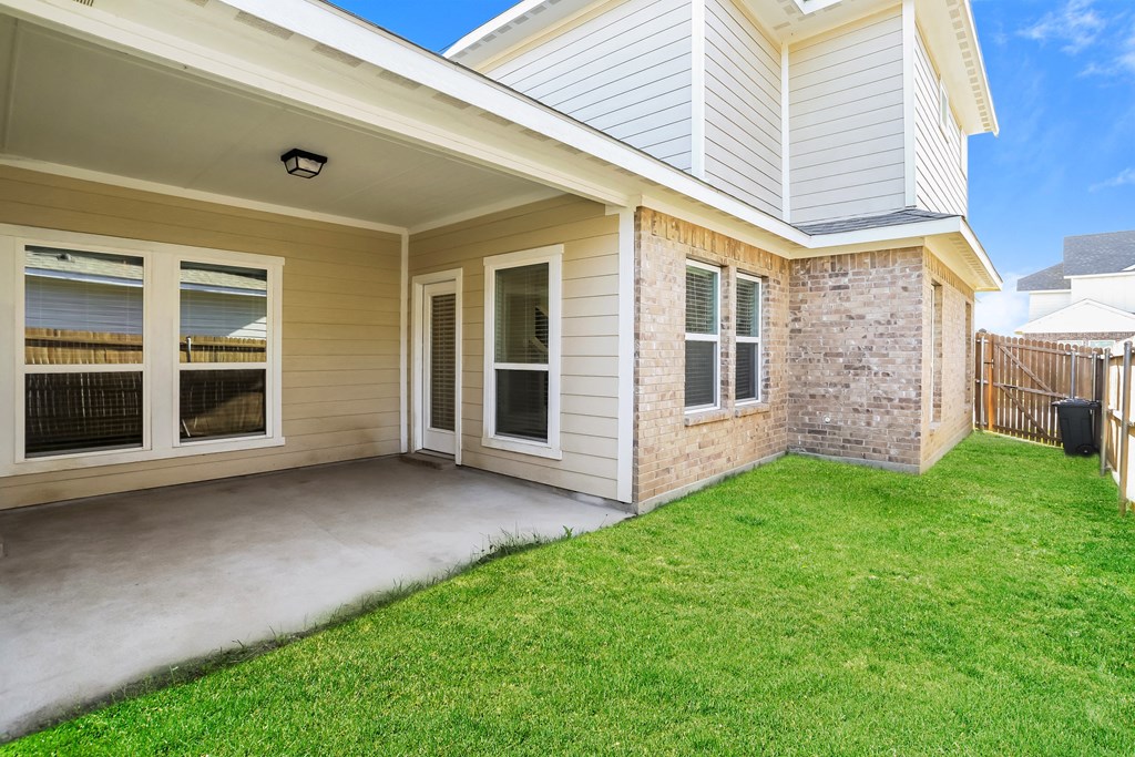 the front porch of a new home with a yard and grass