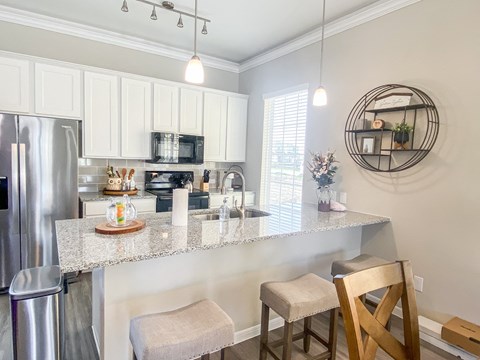 a kitchen with a counter top and a stainless steel refrigerator