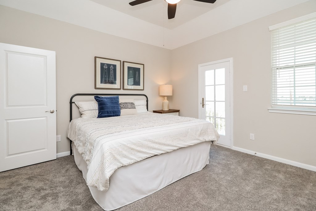 a bedroom with a bed and a ceiling fan