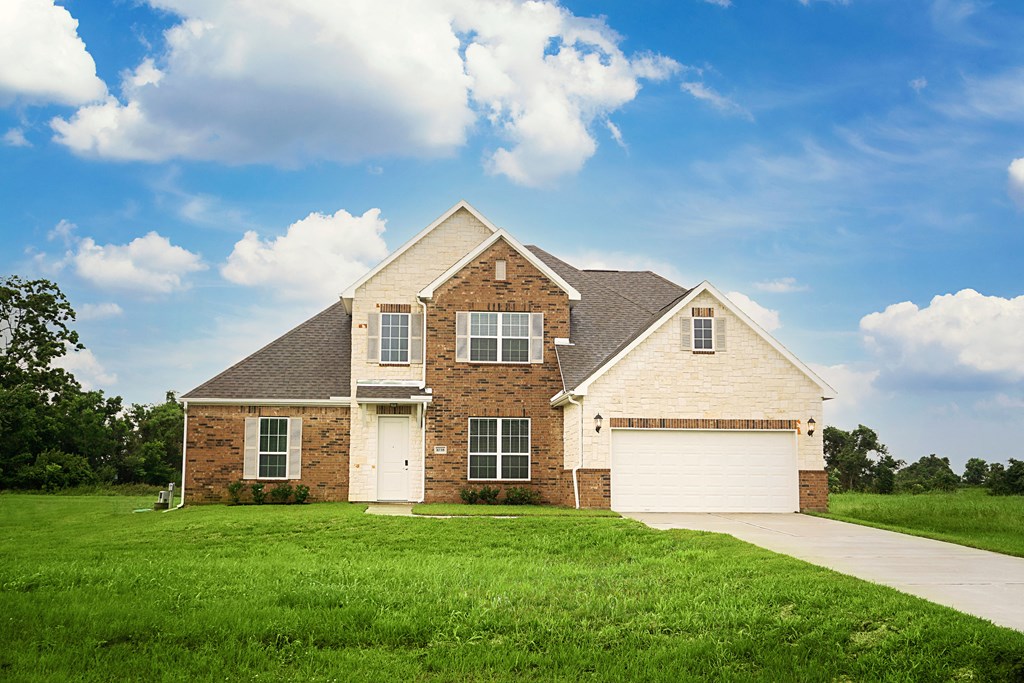 a brick house with a lawn in front of it
