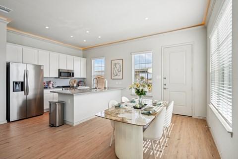 A kitchen with a table set for a meal.