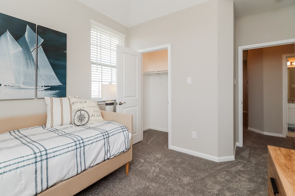 a bedroom with a bed and a door to a bathroom