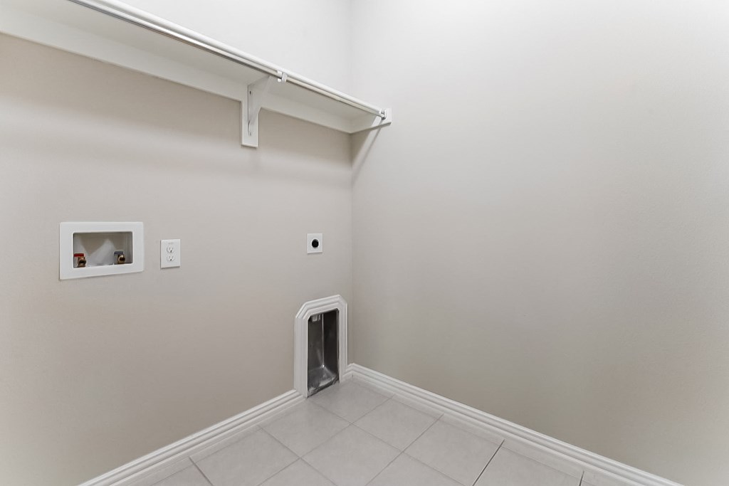 a white room with a cat door in the middle of it
