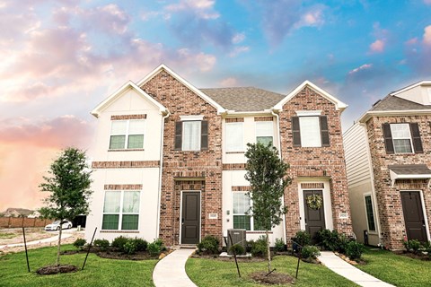A row of houses with a white walkway between them.