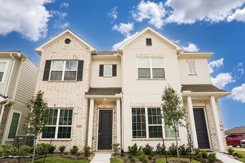 A white house with a black door and windows.