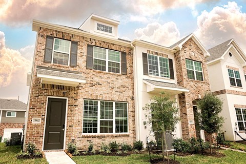 A house with a brown door and windows.