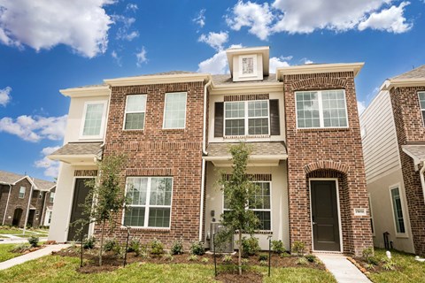 A row of houses with a blue sky in the background.